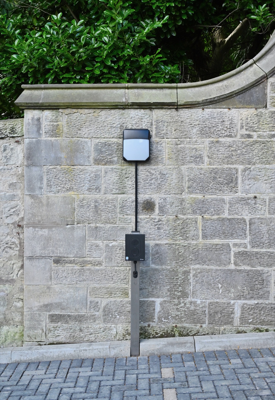 EV charging point mounted on the exterior wall of a Naturi Homes property