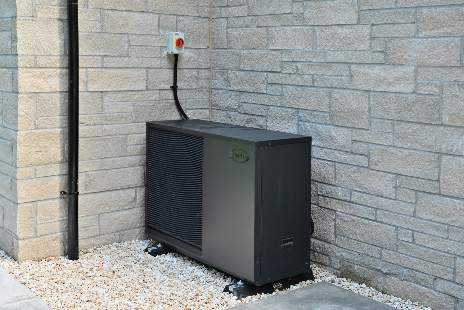 Air source heat pump installed outside a Naturi Homes property